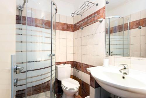 a bathroom with a toilet and a sink at Balaris Apartments in Kassiopi