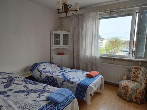 a bedroom with two beds and a window at Cozy Nest, apartement in the center of Rovaniemi in Rovaniemi