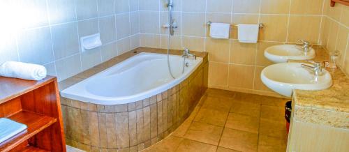 a bathroom with a tub and a sink at Mara Leisure Camp in Talek