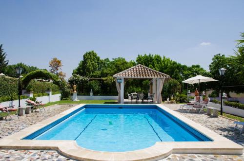 a swimming pool in a yard with a gazebo at Villa Vacacional Los Naranjos in Montemayor