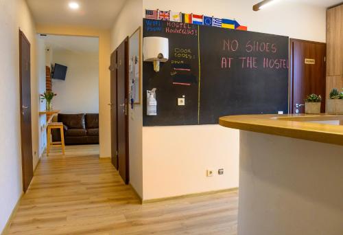 a kitchen with a blackboard with no shoes at the hospital at Klaipeda Hostel in Klaipėda