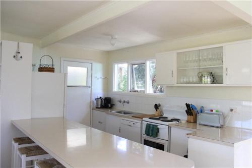 a kitchen with white cabinets and a white counter top at Blairgowrie Beach Escape in Blairgowrie