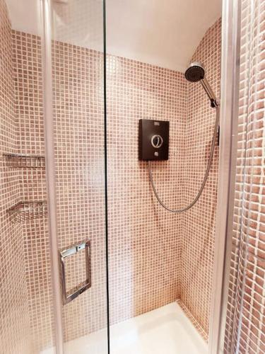a shower in a bathroom with a glass shower stall at Crossways Cottage - Symonds Yat in Symonds Yat