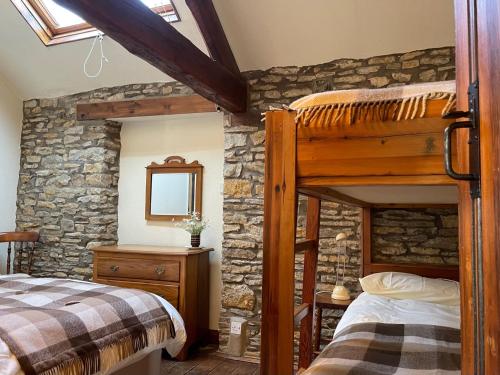 a bedroom with two bunk beds and a mirror at Phlomis in York