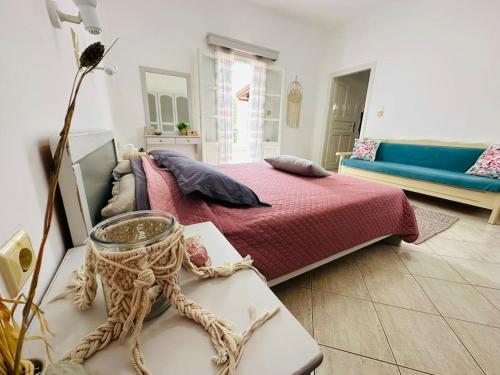 a bedroom with a large bed and a couch at Your perfect escape in Emporios! in Kalymnos