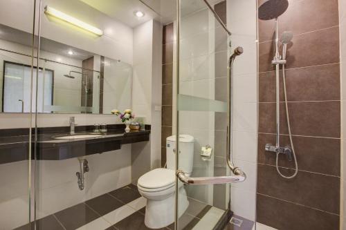a bathroom with a shower and a toilet and a sink at TQT Hotel in Hanoi