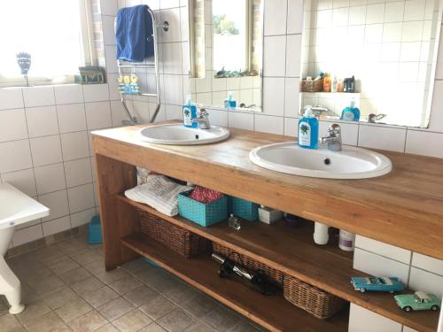 a bathroom with two sinks and a mirror at Bo nära strand och city. in Västra Frölunda