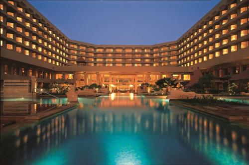 a hotel with a large pool in front of it at JW Marriott Mumbai Juhu in Mumbai