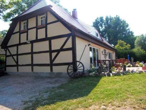 a large white and black house with a yard at Ruegen Fewo 119 in Groß Schoritz