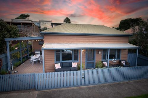 a small house with a fence in front of it at Want extra FREE nighly stays added to your booking Shoot me a message before you book to find out how in Queenscliff