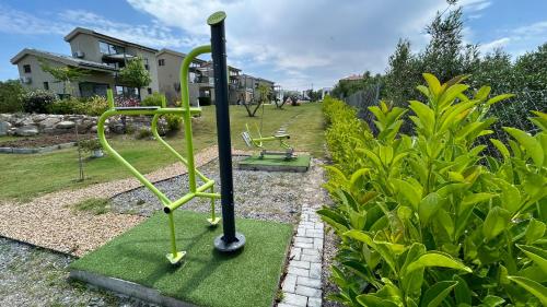a playground in a yard with green equipment at Miroes Suites in Nikiti