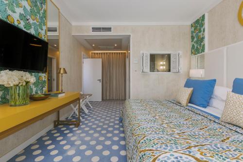 a hotel room with a bed and a television at Bela Vista Hotel & Spa - Relais & Chateaux in Portimão