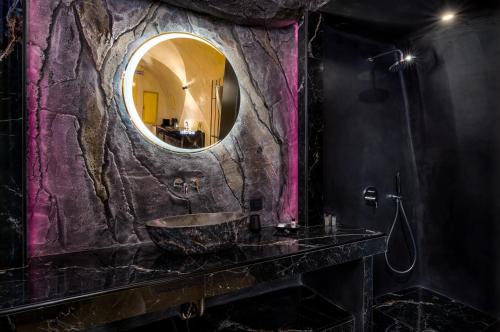 a bathroom with a sink and a mirror at Canyon Santorini in Fira