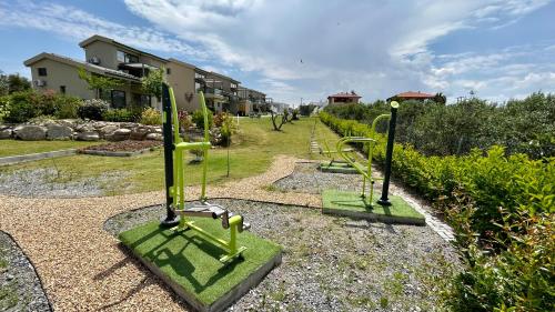 a park with a bunch of golf equipment in a yard at Miroes Suites in Nikiti