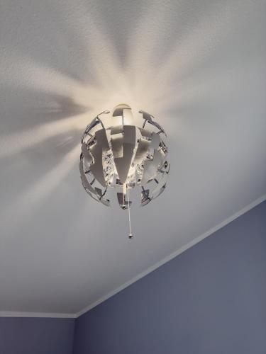 a chandelier hanging from a ceiling in a room at Ruhiges Juwel: frisch renoviert 100 qm in Jülich