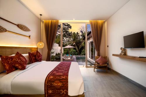a bedroom with a large bed and a tv at Villa Sunrise by BaliSuperHost in Ubud