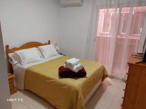 a bedroom with a bed with a towel on it at Alojamiento turistico Ribagorza in El Lligallo del Gànguil