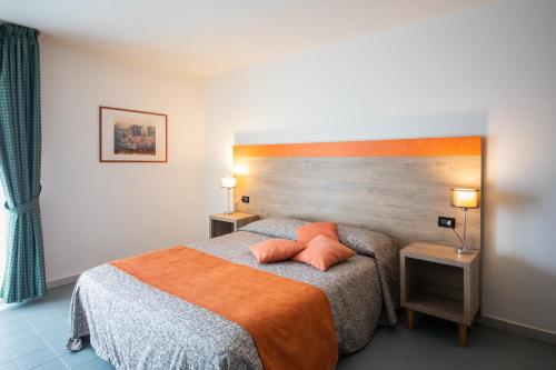 a bedroom with a bed with two pillows on it at Albergo Athenaeum in Palermo