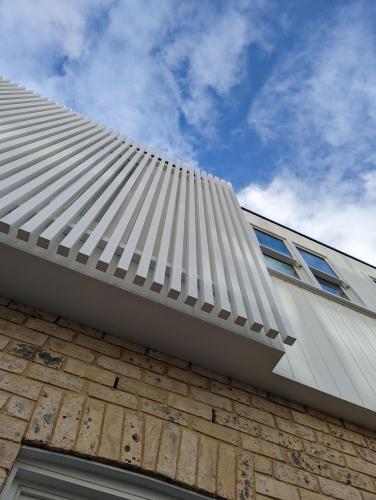a white roof on the side of a building at The Manly House - 100 steps from Manly Beach in Sydney