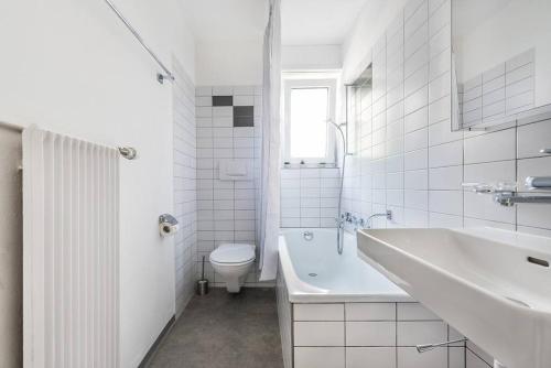a white bathroom with a sink and a toilet at Cooldis 12 !Gratis Parken, Free Parking! in Kreuzlingen
