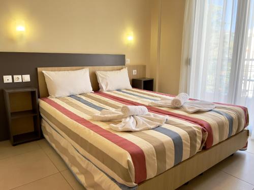 a bedroom with a large bed with towels on it at Skiathos Somnia in Skiathos