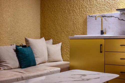 a living room with a couch and a sink at Canyon Santorini in Fira