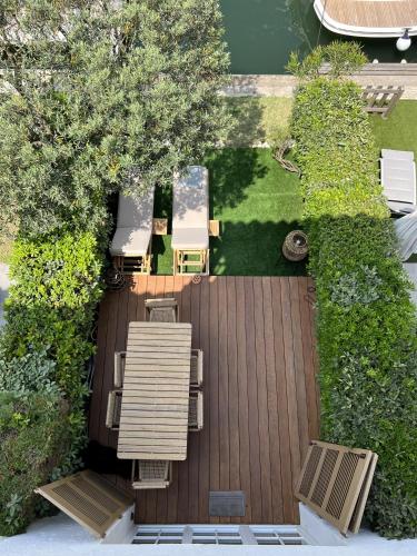 an aerial view of a deck with tables and chairs at Casa iKa Port Grimaud - Maison 4 chambres + amarrage in Grimaud