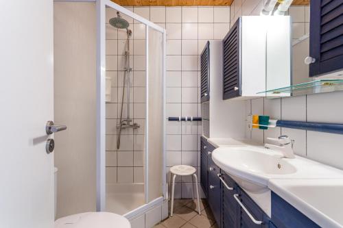 a bathroom with a sink and a toilet and a shower at Cosy Holiday Cottage in Tossa de Mar