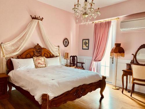 a bedroom with a large bed with a canopy at 法國小古堡- 包棟-Chateau de France in Wujie