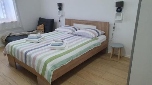 a bedroom with a bed with two towels on it at Apartments Vera Barbariga in Barbariga
