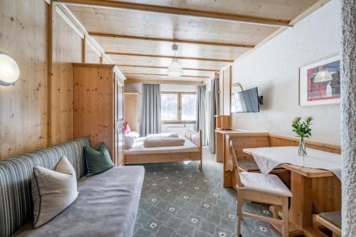 a living room with a couch and a table at Landhaus Edelweiss in Sankt Leonhard im Pitztal