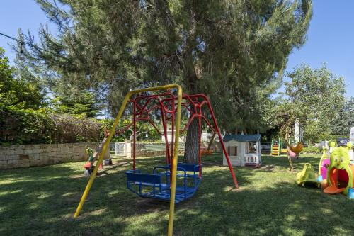 a playground with a swing set in a yard at Agriturismo Salinola 3 in Ostuni