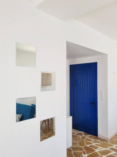 a blue door in the middle of a room at SempreViva Sea Houses in Dhiakofti