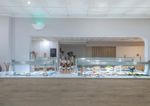 a buffet line with many different types of food at FERGUS Club Carema Splash in Fornells