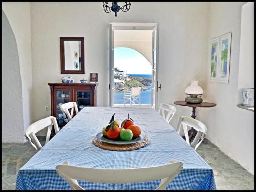 a table with a bowl of fruit on a plate at Greek traditional Island Villa Sai Villa in Loutrá