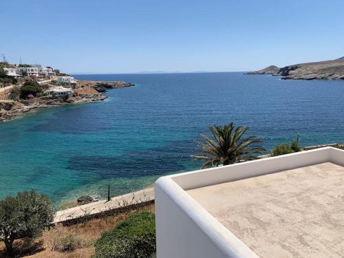 a view of the ocean from the balcony of a house at Greek traditional Island Villa Sai Villa in Loutrá
