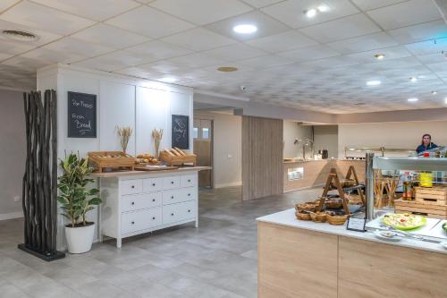 a store with a counter with food on it at FERGUS Club Carema Splash in Fornells