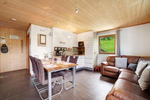 a kitchen and dining room with a table and a couch at Joshof Bergblick in Stulles