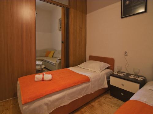 a hotel room with a bed and a mirror at Apartment Manuela in Dubrovnik