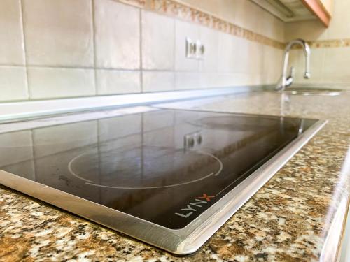 a tablet on a counter in a kitchen at Vivienda Turística Los Leones in Berlanga de Duero