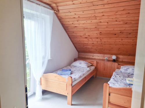 a small bedroom with a bed and a window at Apartma Gea, Terme Olimia in Podčetrtek