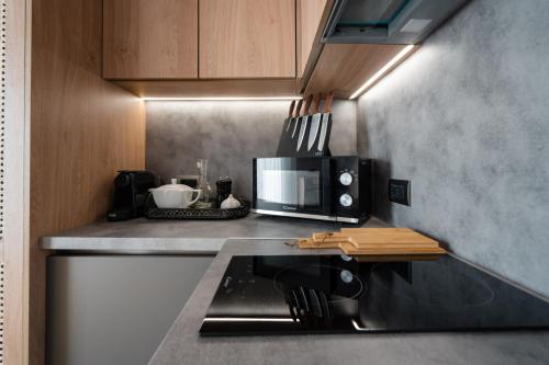 a kitchen with a counter top with a microwave at Acropolis Luxury Penthouses with Majestic Views in Athens