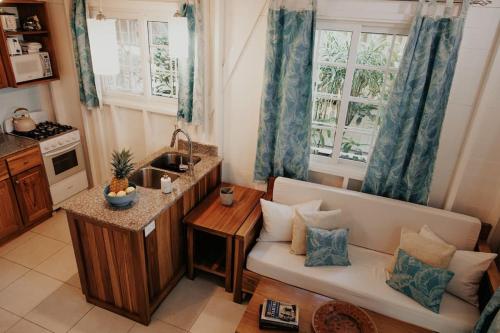 a living room with a couch and a kitchen at CoconutTree Bungalow of Villa Paraiso / Beachfront in Big Creek