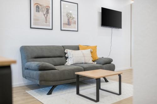 a living room with a couch and a table at Hotel Maslina in Seget