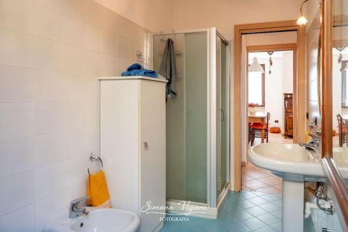 a bathroom with a sink and a shower and a toilet at Il Giardino di Laura in Costa Volpino
