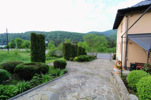 a garden with a stone walkway next to a house at Cottage "Lure" in Yaremche
