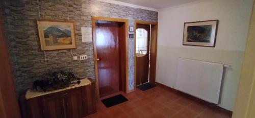a hallway with a door and a brick wall at Apartmani Horvat - Varaždinske Toplice in Varaždinske Toplice