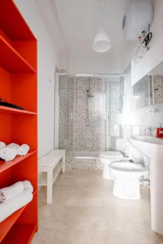 a white bathroom with two toilets and a shower at Casa Bella in Gela