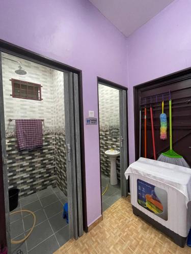 a bathroom with a walk in shower next to a door at Homestay Ummi Pendang in Pendang