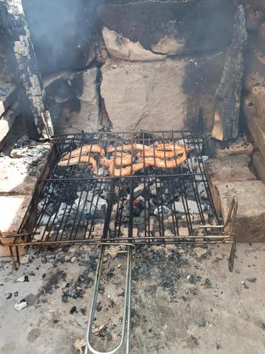 a grill with a bunch of hot dogs on it at La Casa de Salinas in Salinas de Pisuerga